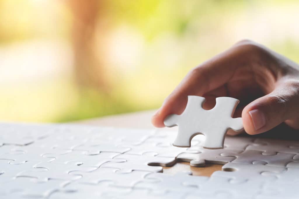 image of an individual placing a puzzle piece that symbolizes how intensive outpatient alcohol treatment work