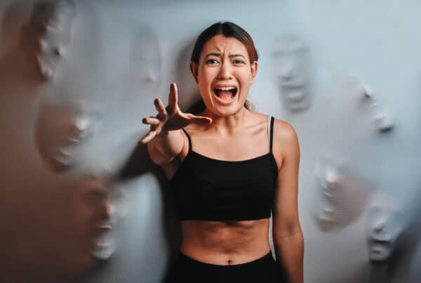 Shot of a young woman experiencing meth-induced psychosis against a spooky background.